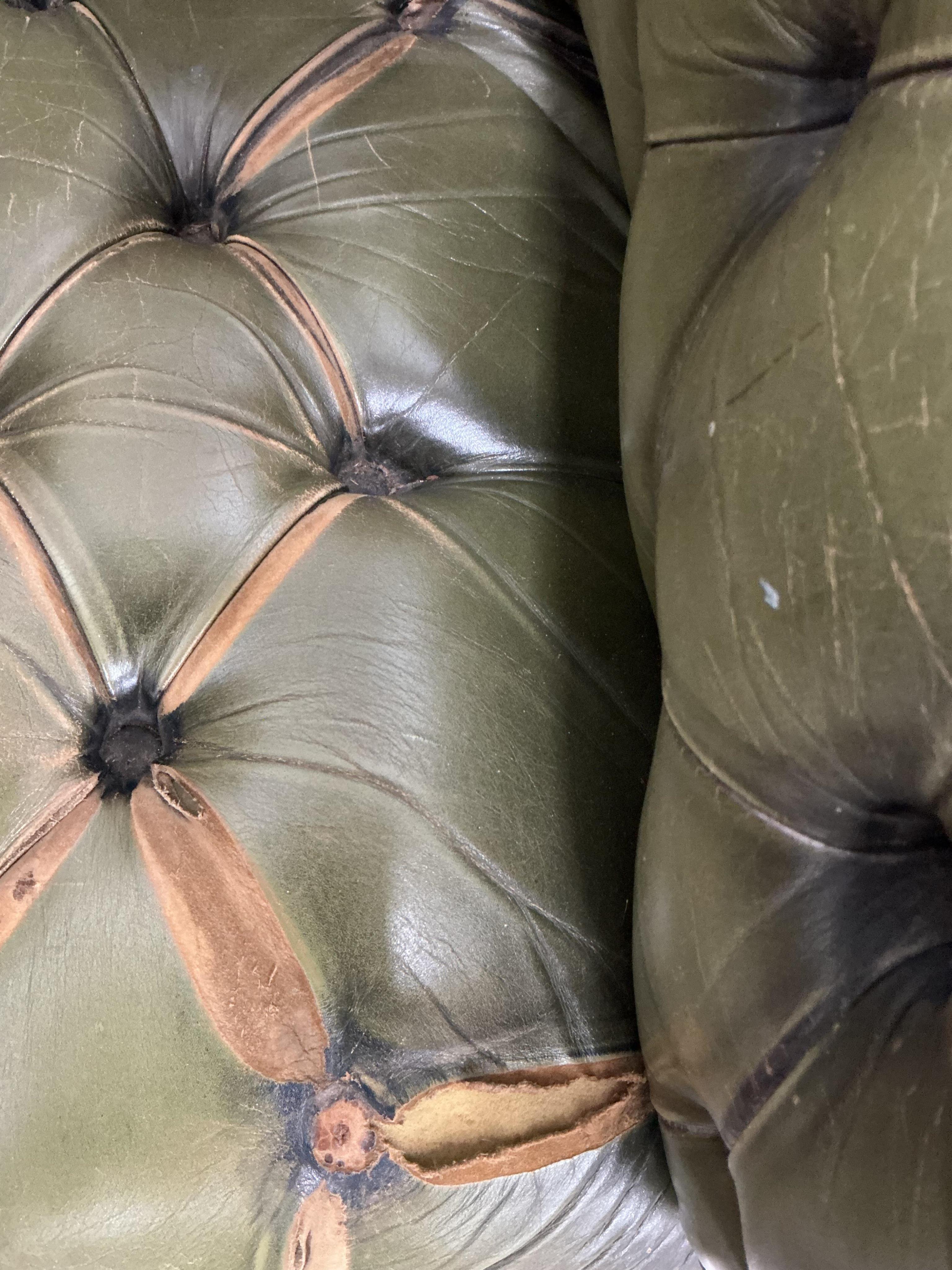 A pair of Chesterfield style buttoned green leather club armchairs, width 104cm, depth 92cm, height 74cm
